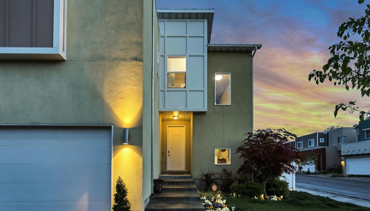 Exterior wall sconce glowing at dusk